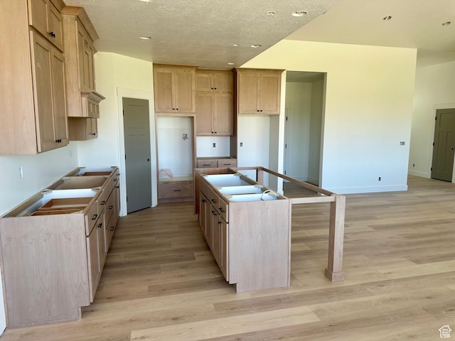 1885 N 4475 W, Plain City, UT 84404 - kitchen with a kitchen island with sink, light wood-type flooring, recessed lighting, and a textured ceiling