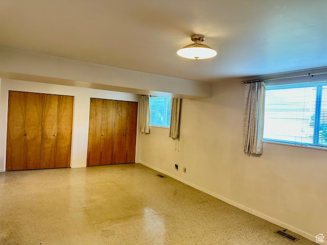 372 E 800 N, Logan, UT 84321 - unfurnished bedroom with baseboards and multiple closets