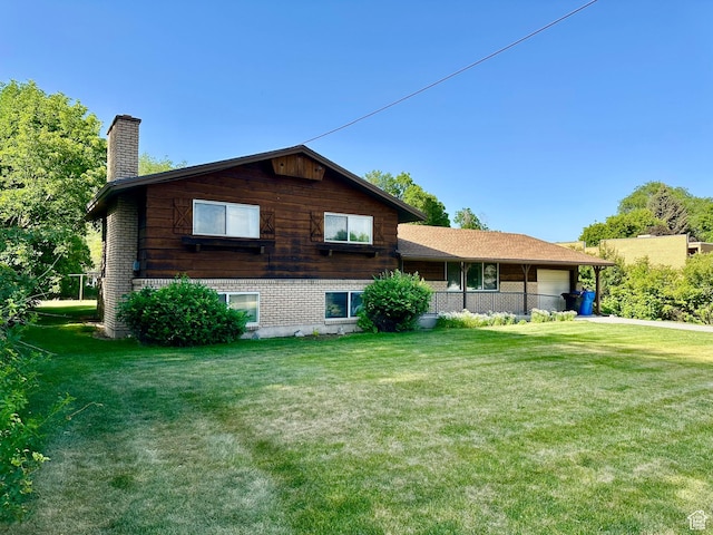 372 E 800 N, Logan, UT 84321 - rear view of property with a chimney, a yard, an attached garage, and brick siding
