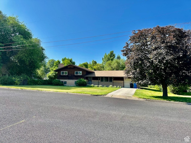 372 E 800 N, Logan, UT 84321 - split level home featuring a chimney, a garage, a front yard, and concrete driveway