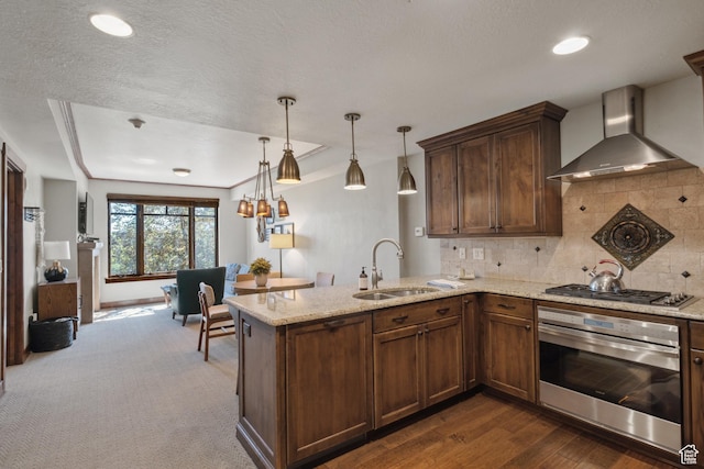 3558 Escala Ct Unit 252, Park City, UT 84098 - kitchen with stainless steel appliances, wall chimney exhaust hood, tasteful backsplash, light stone counters, and a peninsula