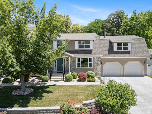 1700 N Bluebird Rd, Orem, UT 84097 - view of front of home with stone siding, driveway, roof with shingles, and a front yard