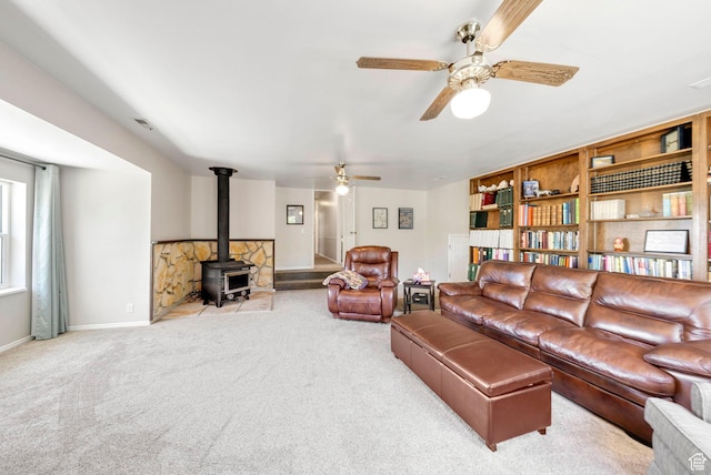 1700 N Bluebird Rd, Orem, UT 84097 - living area with a wood stove, carpet, and ceiling fan
