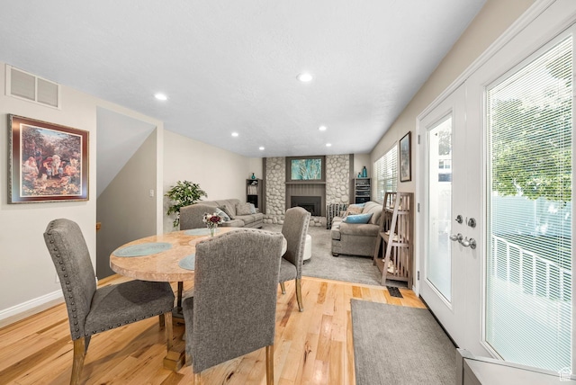 1700 N Bluebird Rd, Orem, UT 84097 - dining area with light wood finished floors, a brick fireplace, and recessed lighting