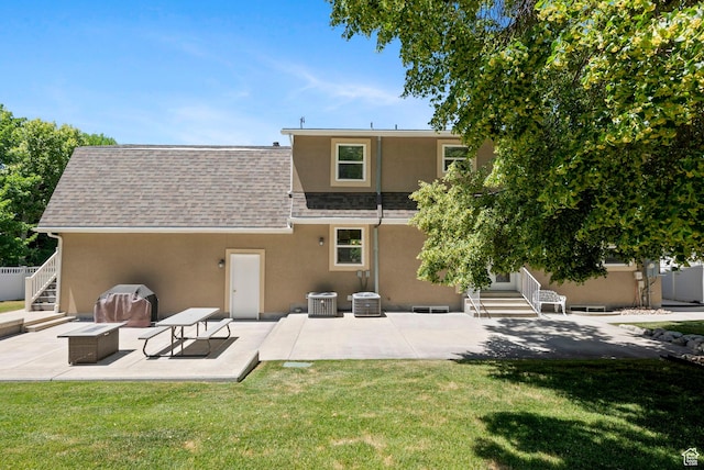 1700 N Bluebird Rd, Orem, UT 84097 - back of property featuring stucco siding, a patio area, a lawn, and roof with shingles