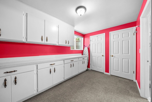 1700 N Bluebird Rd, Orem, UT 84097 - kitchen featuring light countertops, white cabinetry, and light colored carpet