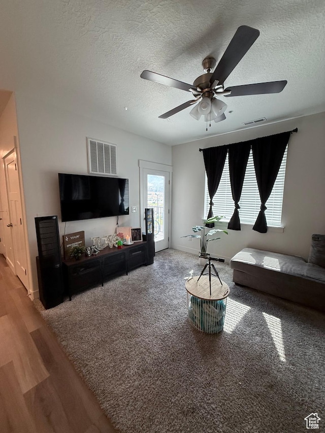 13547 S Hanley Ln Unit 202, Riverton, UT 84096 - carpeted living area featuring a ceiling fan, a textured ceiling, and wood finished floors