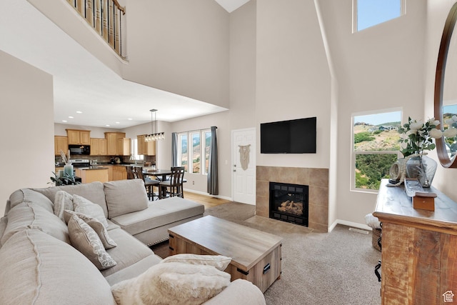 923 E Absaroka Ct S, Draper, UT 84020 - living room featuring a towering ceiling, a tile fireplace, light carpet, and recessed lighting