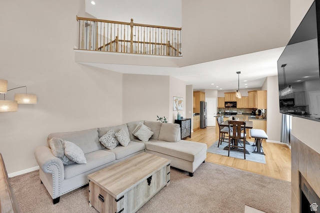 923 E Absaroka Ct S, Draper, UT 84020 - living area featuring recessed lighting, a high ceiling, light wood-style floors, and light carpet