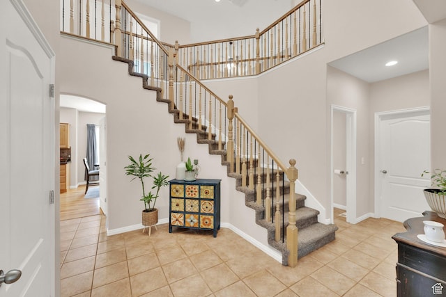 923 E Absaroka Ct S, Draper, UT 84020 - stairway featuring a high ceiling, tile patterned flooring, and arched walkways