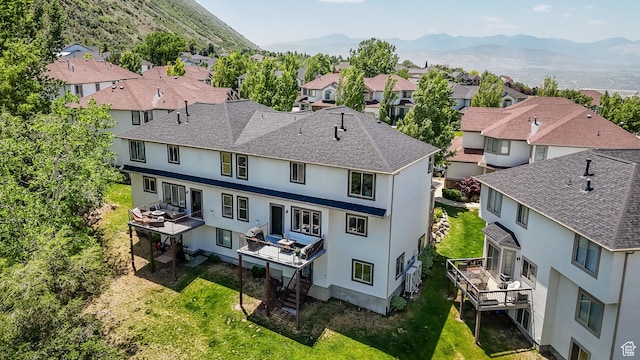 923 E Absaroka Ct S, Draper, UT 84020 - back of house with a residential view, stucco siding, a yard, and roof with shingles