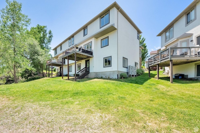 923 E Absaroka Ct S, Draper, UT 84020 - rear view of property with stucco siding, a wooden deck, and a yard