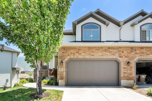 923 E Absaroka Ct S, Draper, UT 84020 - view of front of property featuring stone siding, a garage, driveway, and stucco siding