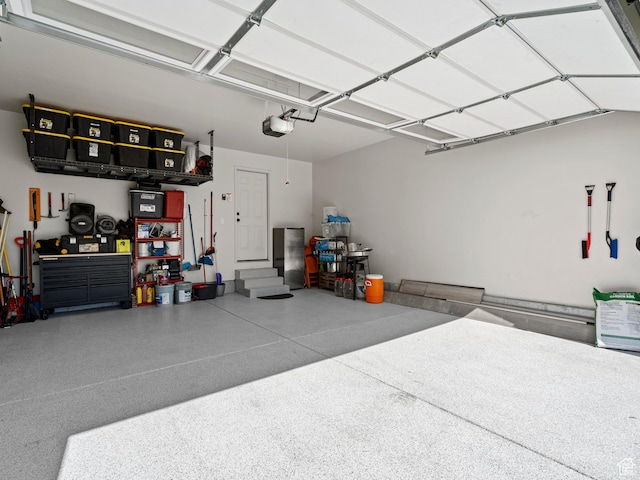 214 S 900 W, Tooele, UT 84074 - garage with a garage door opener and a workshop area