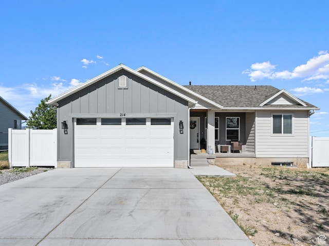 214 S 900 W, Tooele, UT 84074 - single story home featuring an attached garage, covered porch, driveway, board and batten siding, and a shingled roof