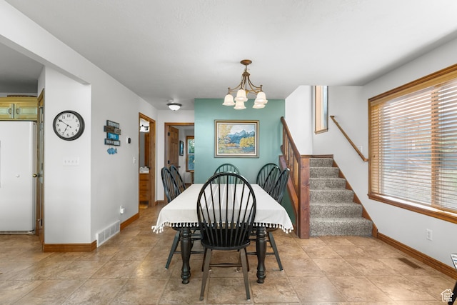 1340 N Trapper Loop, Garden City, UT 84028 - dining area featuring a chandelier and stairway