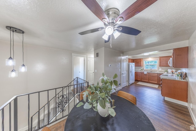 774 W 4375 S, Riverdale, UT 84405 - dining room with dark wood-type flooring, a textured ceiling, and ceiling fan