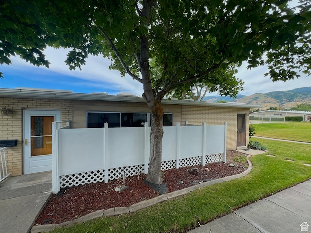 399 W 400 N Unit 47, Bountiful, UT 84010 - view of home's exterior with brick siding, a mountain view, and a yard