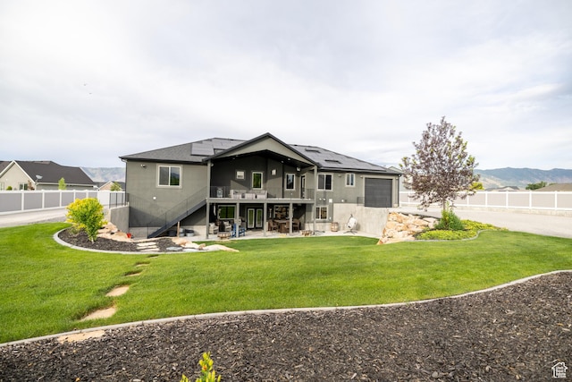 4311 N Diamond Ln, Erda, UT 84074 - rear view of house with stairs, solar panels, a fenced backyard, a patio, and a garage