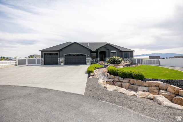 4311 N Diamond Ln, Erda, UT 84074 - view of front facade with an attached garage, stone siding, driveway, and a shingled roof