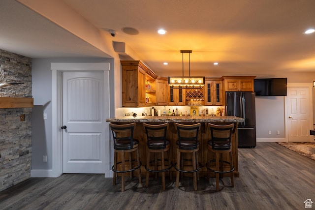 4311 N Diamond Ln, Erda, UT 84074 - indoor wet bar with freestanding refrigerator, dark wood-type flooring, hanging light fixtures, and recessed lighting