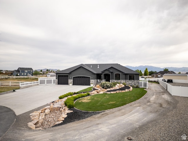 4311 N Diamond Ln, Erda, UT 84074 - single story home with driveway, a garage, a mountain view, stucco siding, and stone siding
