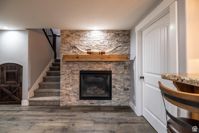 4311 N Diamond Ln, Erda, UT 84074 - living area with a stone fireplace, wood finished floors, stairs, and recessed lighting