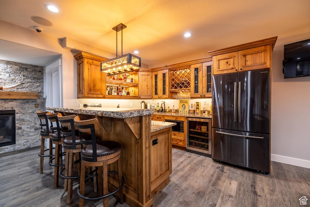 4311 N Diamond Ln, Erda, UT 84074 - indoor wet bar featuring freestanding refrigerator, wine cooler, dark wood-style flooring, pendant lighting, and recessed lighting