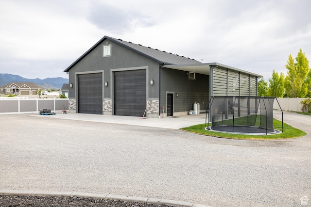 4311 N Diamond Ln, Erda, UT 84074 - garage featuring a trampoline and a mountain view
