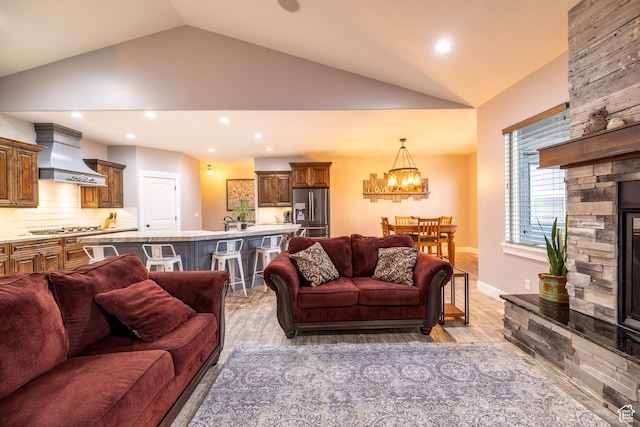 4311 N Diamond Ln, Erda, UT 84074 - living area with vaulted ceiling, a chandelier, light wood finished floors, and recessed lighting