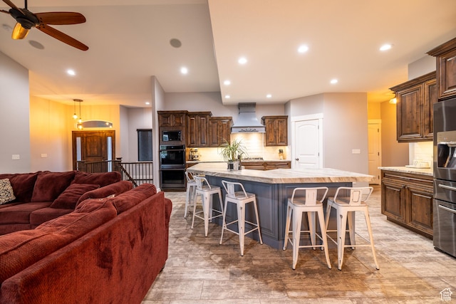 4311 N Diamond Ln, Erda, UT 84074 - kitchen featuring custom range hood, black appliances, open floor plan, light countertops, and a ceiling fan