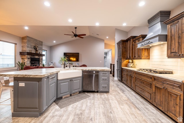4311 N Diamond Ln, Erda, UT 84074 - kitchen with stainless steel appliances, ceiling fan, open floor plan, a stone fireplace, and vaulted ceiling