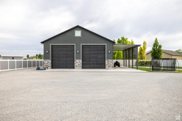 4311 N Diamond Ln, Erda, UT 84074 - garage with a trampoline and a detached garage