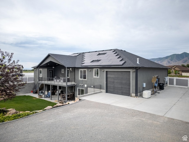 4311 N Diamond Ln, Erda, UT 84074 - view of front of house featuring a garage, solar panels, concrete driveway, stairs, and roof with shingles