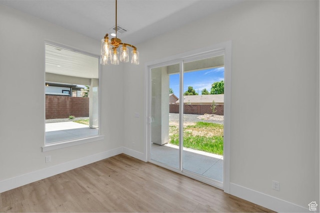 21 W Elinor Ln, Washington, UT 84780 - unfurnished dining area with a chandelier, healthy amount of natural light, and wood finished floors
