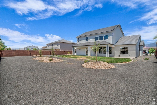 21 W Elinor Ln, Washington, UT 84780 - back of house with stucco siding and a tiled roof