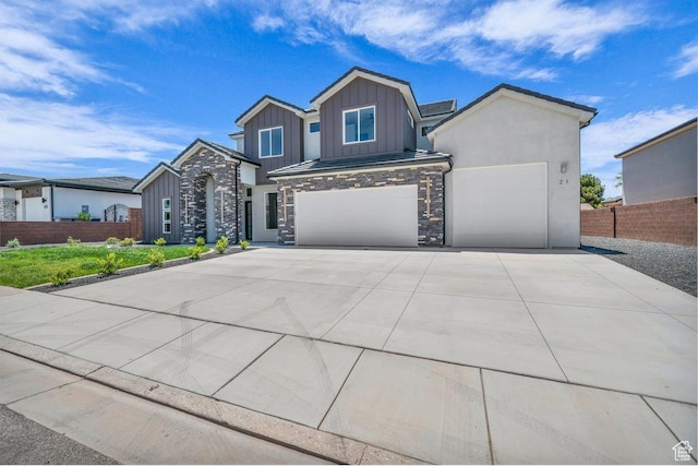 21 W Elinor Ln, Washington, UT 84780 - view of front of property featuring board and batten siding, stone siding, driveway, and a garage