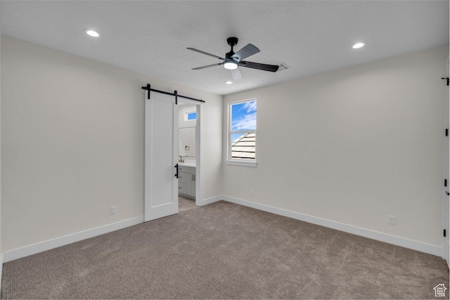 21 W Elinor Ln, Washington, UT 84780 - unfurnished bedroom with a barn door, carpet flooring, recessed lighting, ensuite bath, and a ceiling fan