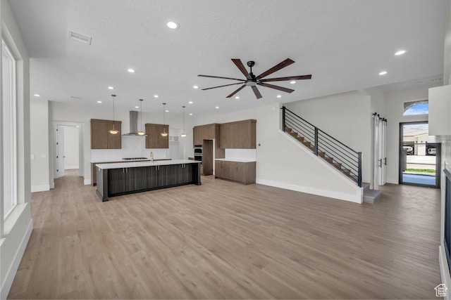 21 W Elinor Ln, Washington, UT 84780 - unfurnished living room featuring light wood-style floors, recessed lighting, a ceiling fan, and stairway