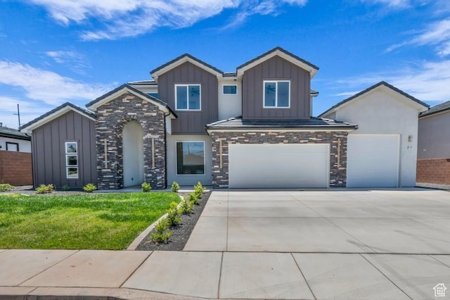 21 W Elinor Ln, Washington, UT 84780 - view of front of home featuring board and batten siding, driveway, stone siding, and a front yard