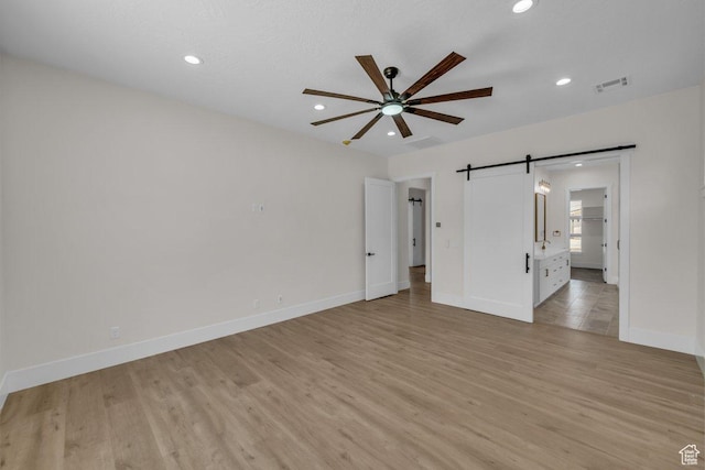 21 W Elinor Ln, Washington, UT 84780 - unfurnished bedroom with a barn door, recessed lighting, light wood-style flooring, ensuite bath, and a ceiling fan
