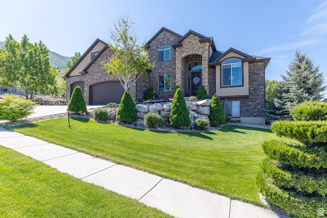 39 E 1800 S, Perry, UT 84302 - view of front of property featuring a front yard, brick siding, concrete driveway, and a garage