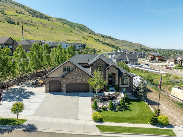 39 E 1800 S, Perry, UT 84302 - view of front of property with stone siding, a residential view, concrete driveway, a mountain view, and a garage