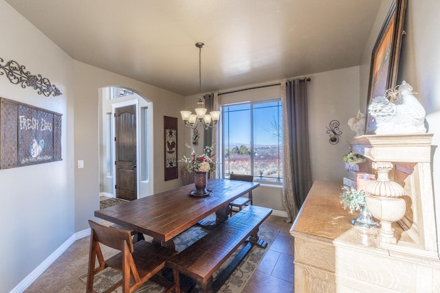 39 E 1800 S, Perry, UT 84302 - dining space with arched walkways, a chandelier, and dark tile patterned floors