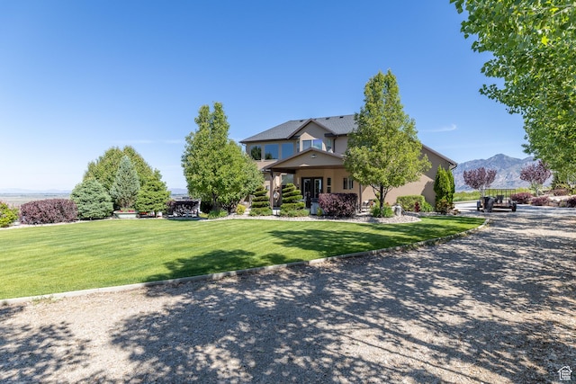 39 E 1800 S, Perry, UT 84302 - view of front of property featuring a front lawn, stucco siding, and a mountain view