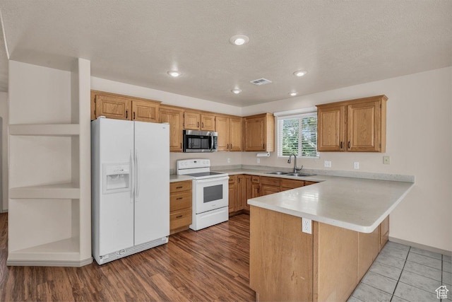 579 E Spring Cir, Washington, UT 84780 - kitchen featuring white appliances, a peninsula, light countertops, recessed lighting, and brown cabinets