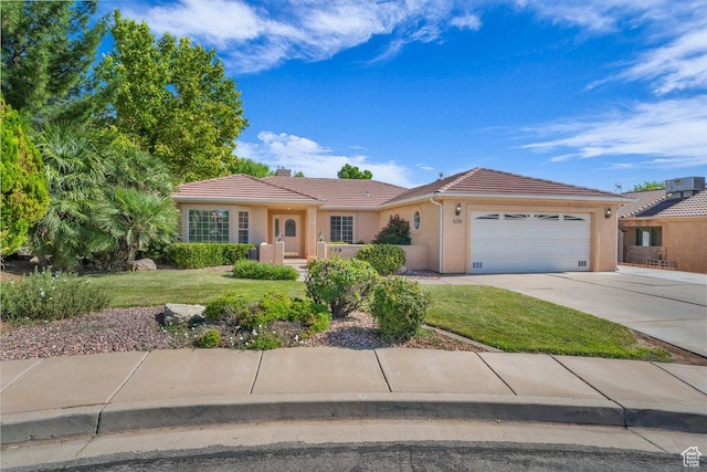 579 E Spring Cir, Washington, UT 84780 - ranch-style home featuring a tiled roof, a garage, a front lawn, and stucco siding