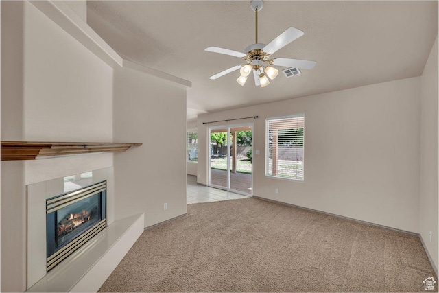 579 E Spring Cir, Washington, UT 84780 - unfurnished living room featuring carpet floors, a ceiling fan, and a glass covered fireplace