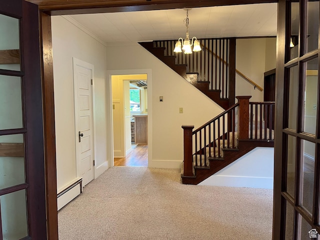 102 N 300 E, Moab, UT 84532 - foyer with a baseboard heating unit, carpet flooring, ornamental molding, stairway, and a chandelier