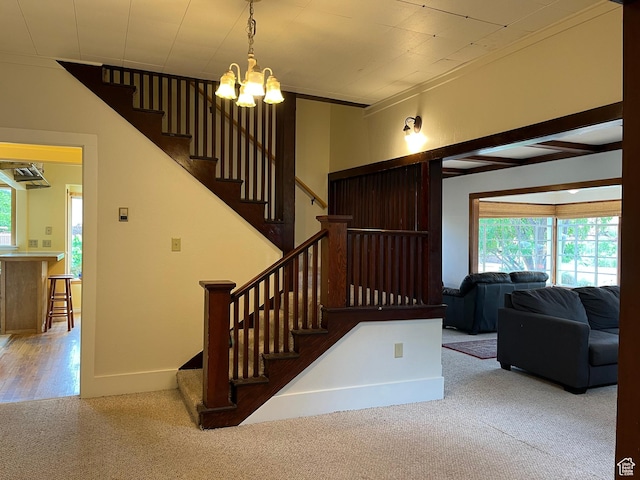 102 N 300 E, Moab, UT 84532 - stairway featuring carpet floors, plenty of natural light, and a chandelier